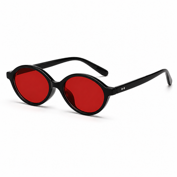 Óculos LUMA Night Black com armação preta oval e lentes vermelhas com filtro de luz azul, em vista 3/4 sobre fundo branco.