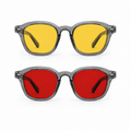 Óculos AURA Kit Day + Night com armação Smoke, apresentados de frente sobre fundo branco, com lentes amarelas na versão Day na parte superior e lentes vermelhas na versão Night na parte inferior.